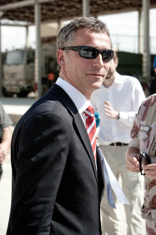 a close up of a man in sunglasses and a tie