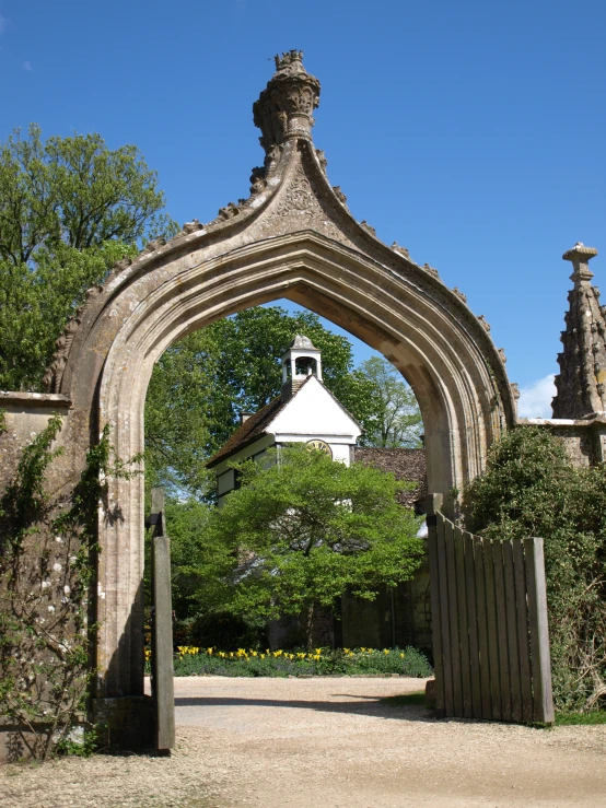 an arch between two buildings with a fence around it