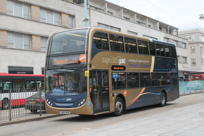 a double decker bus parked near a fence