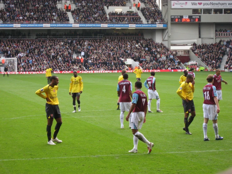 soccer players walk on the field during a match