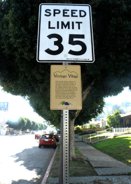 there is a speed limit sign on a street pole