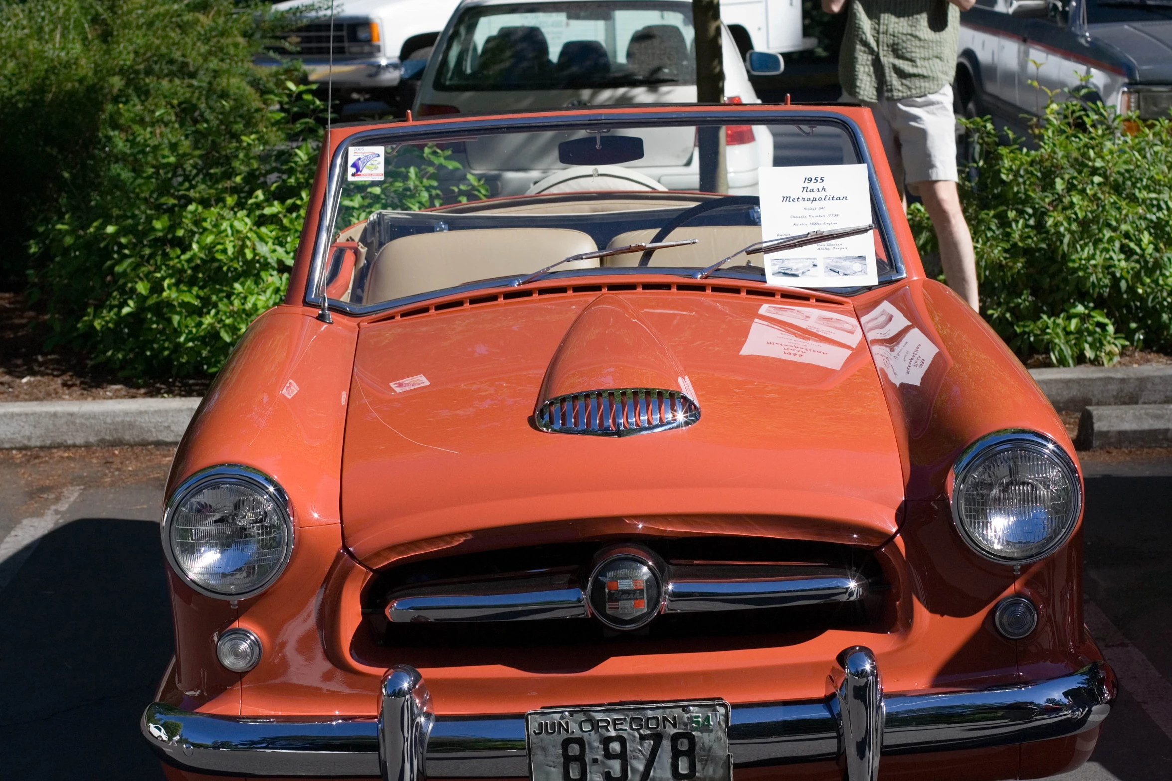 an old orange car with a black leather top