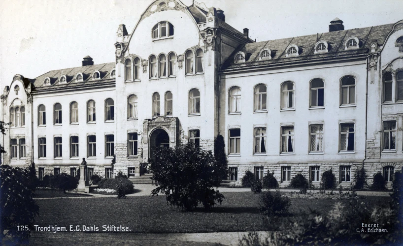 a large building with lots of windows and trees