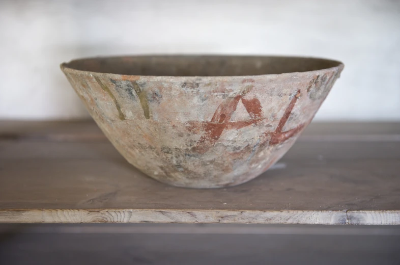 a white bowl with some letters painted on it