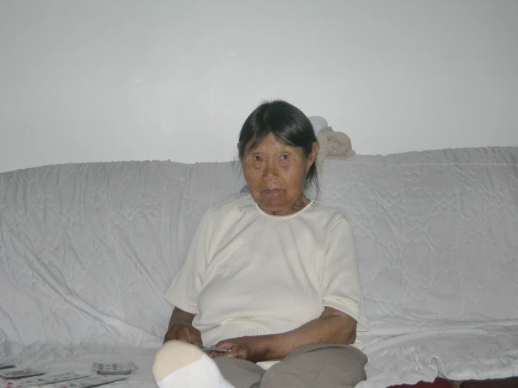 an old woman on a couch with her arm resting