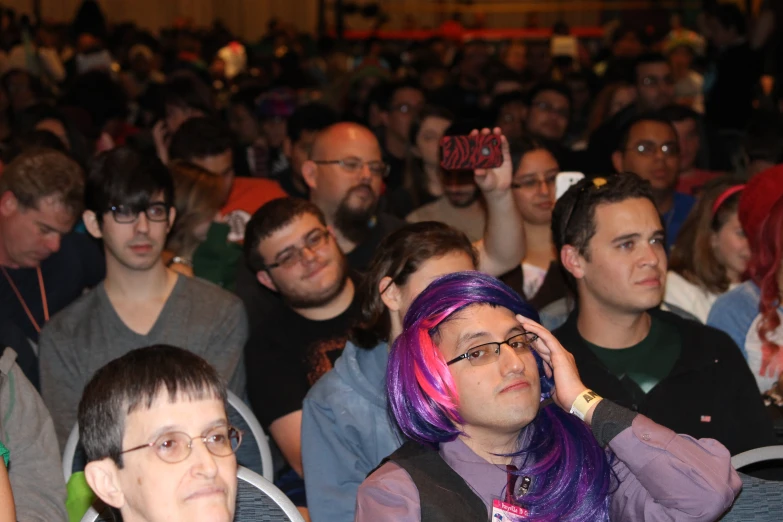 a crowd of people sitting in the audience