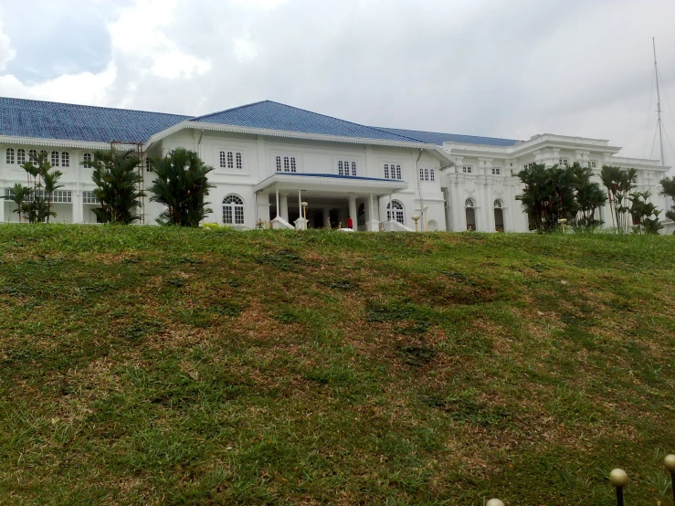 an exterior view of the house with a blue roof