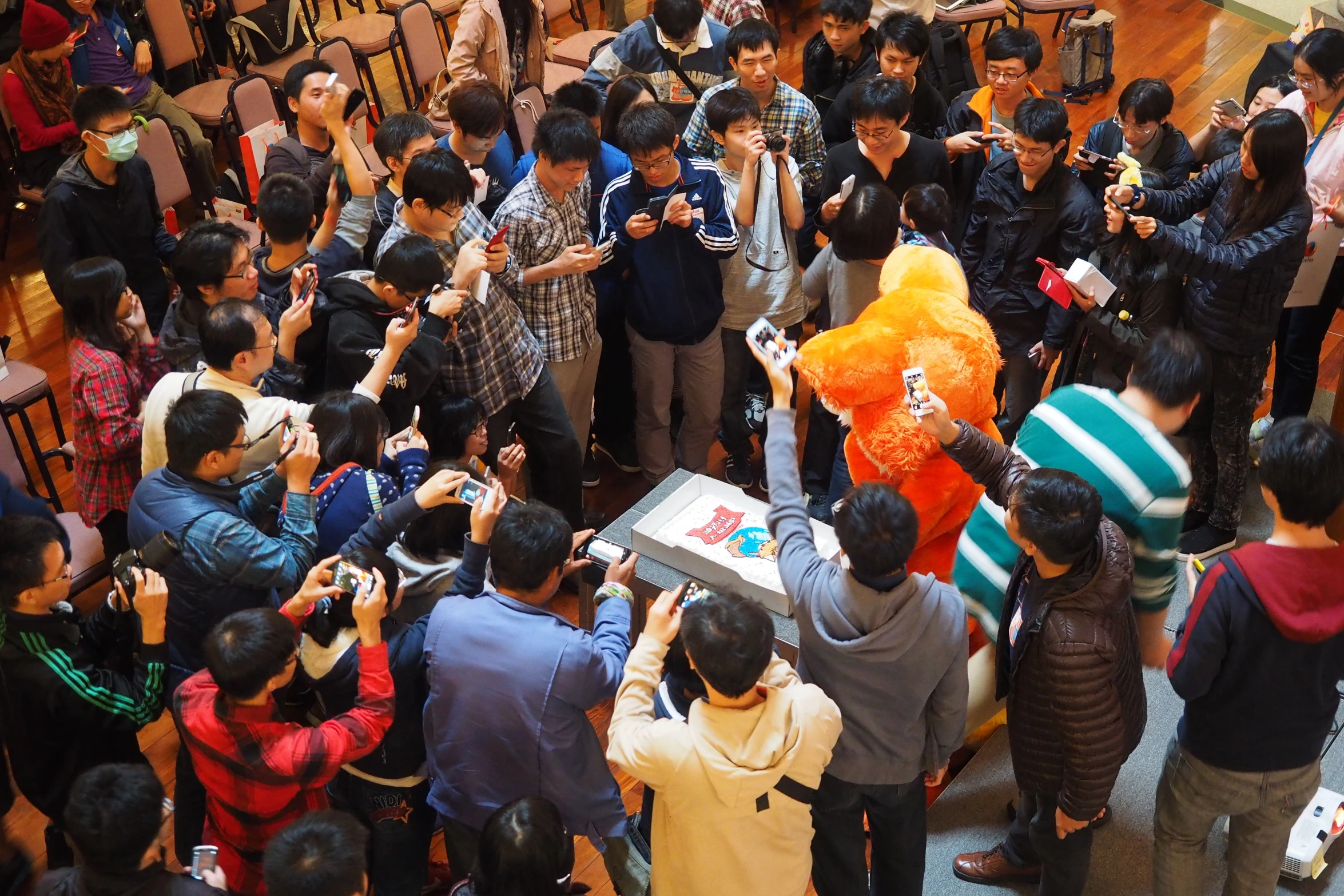 a group of people are standing around taking pictures