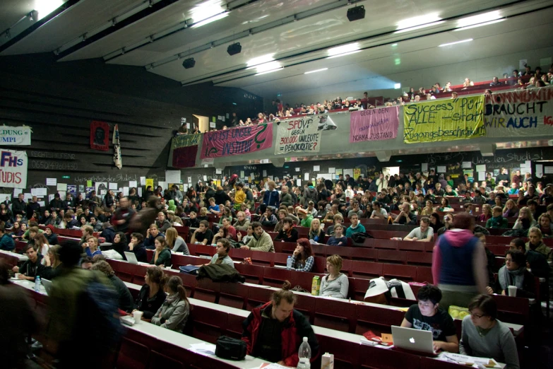 the audience at a political event in a convention hall