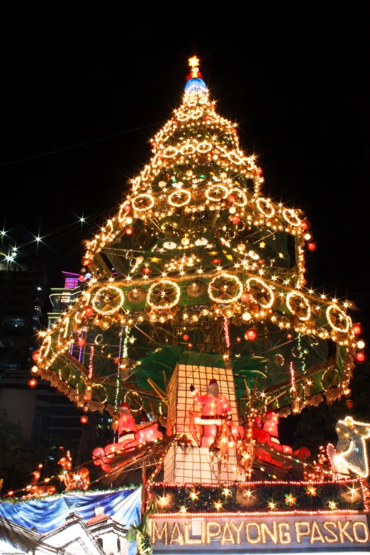 a christmas tree with holiday lights is on display