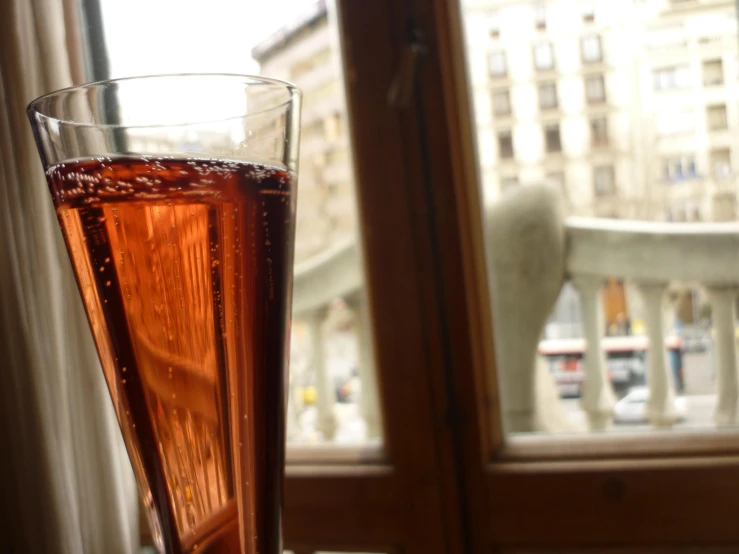 a tall glass of soda sitting on top of a table