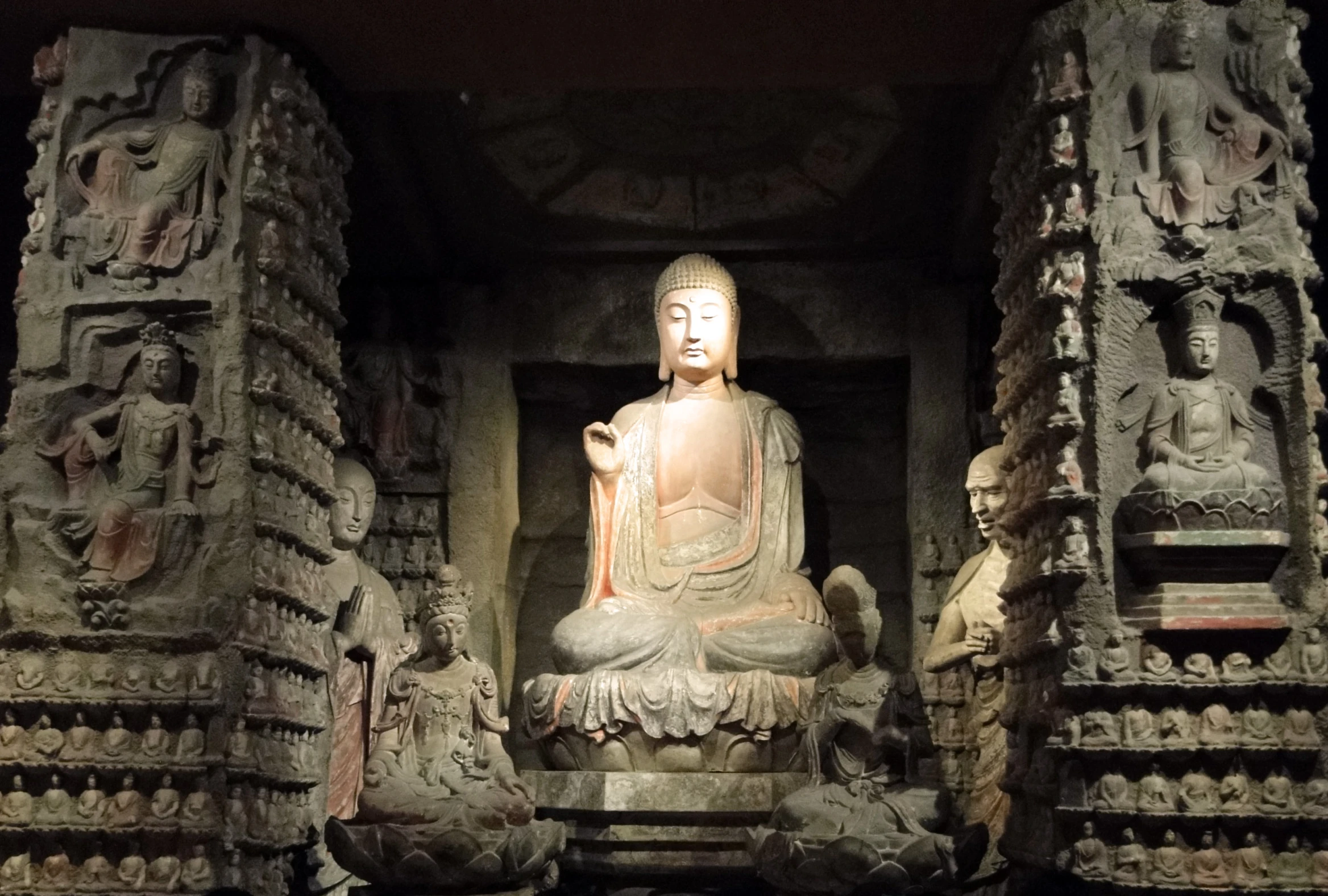 the statues of buddha and other ancient carvings