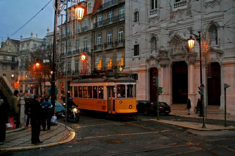 the trolley is waiting in traffic by the building