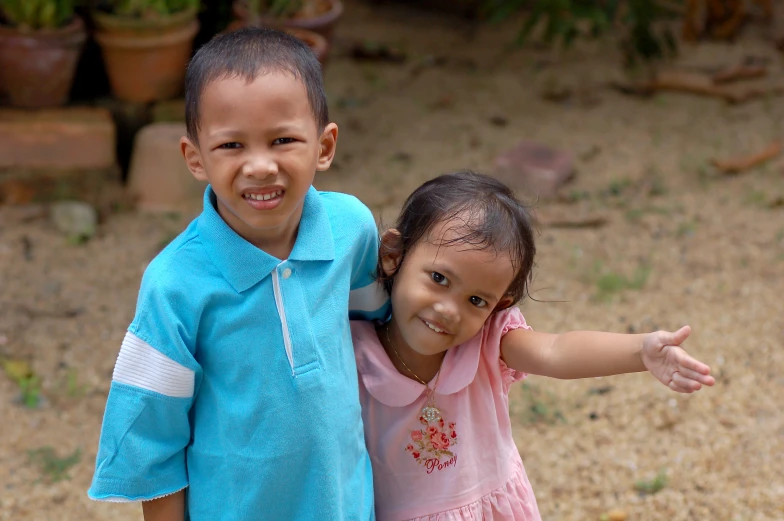 two young children holding their arms around each other