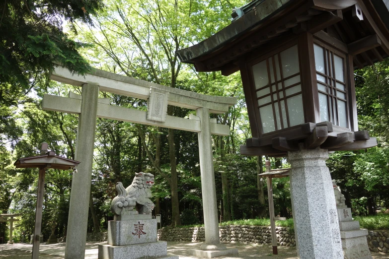 a stone shrine in the middle of a wooded area