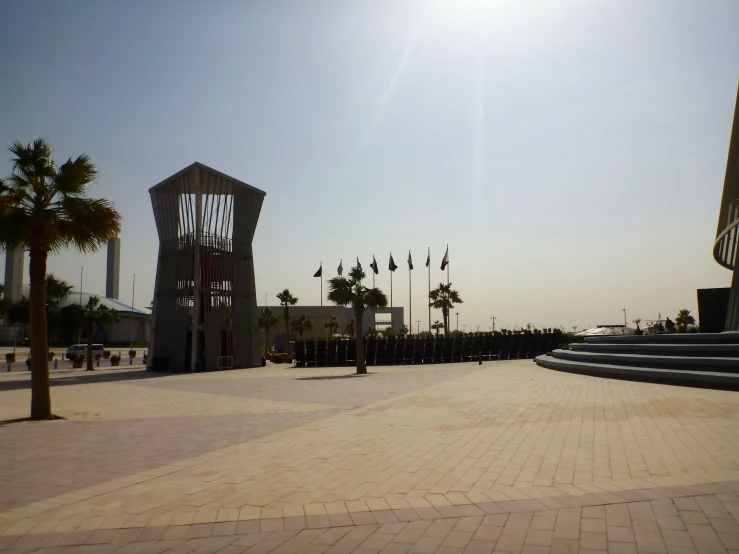 an empty beach area with many palm trees and some large towers