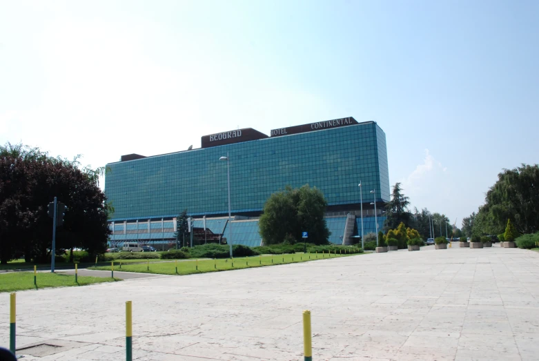 an empty parking lot is near the large building