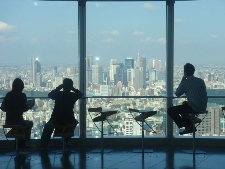 a group of people that are sitting in chairs near a window