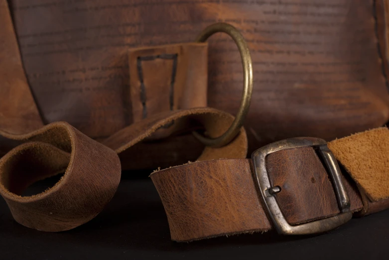 leather straps of some sort attached to a brown bag