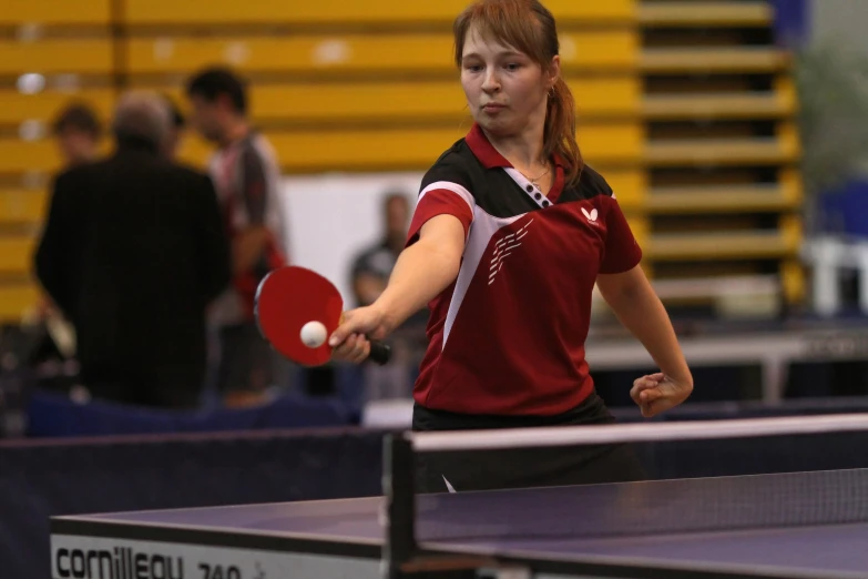 a woman plays table tennis at a sports facility
