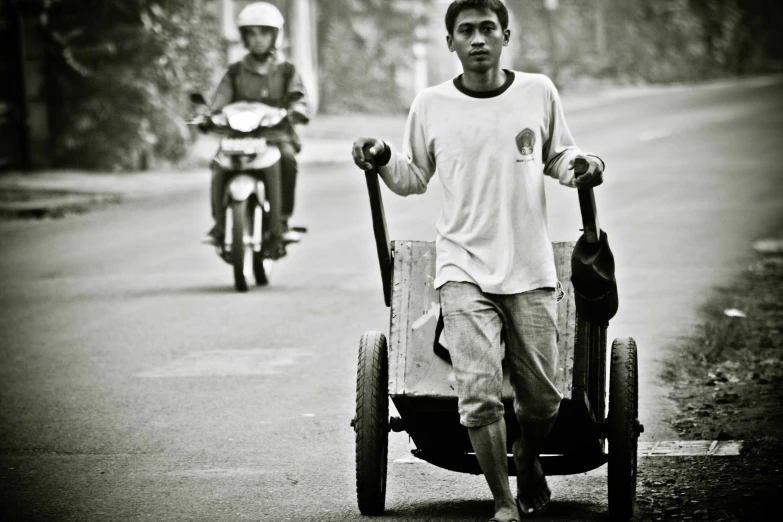 two men ride mopeds and motorcycle carts down the street