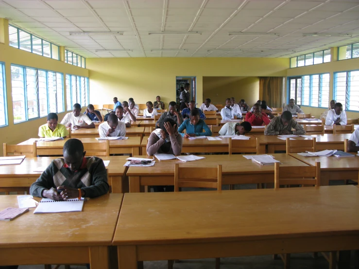 a classroom full of people sitting at desks