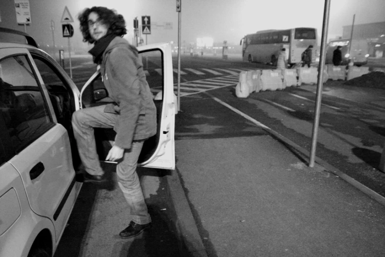 a man getting into a car in an airport