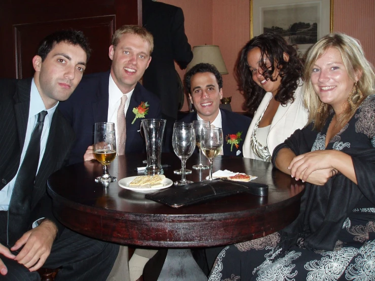 three couples posing for a po at a restaurant