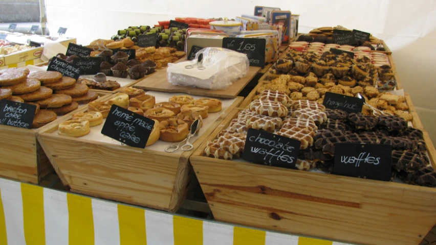 various pastry items on display in wooden boxes