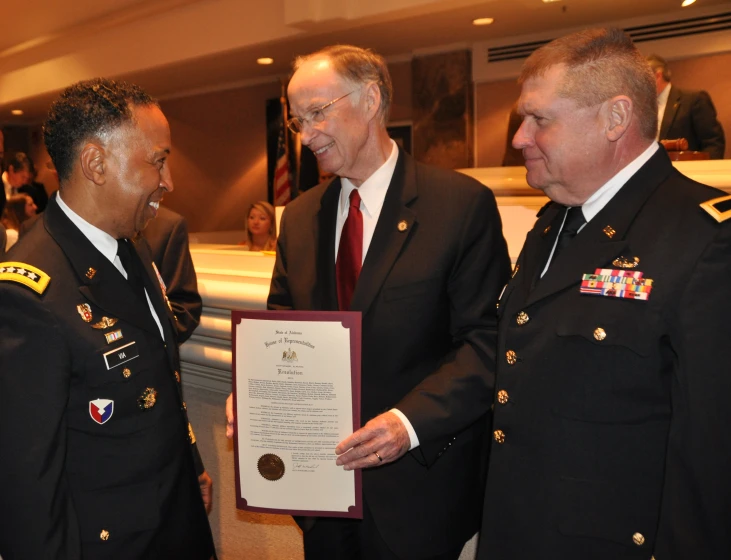 three men in military dress standing next to each other