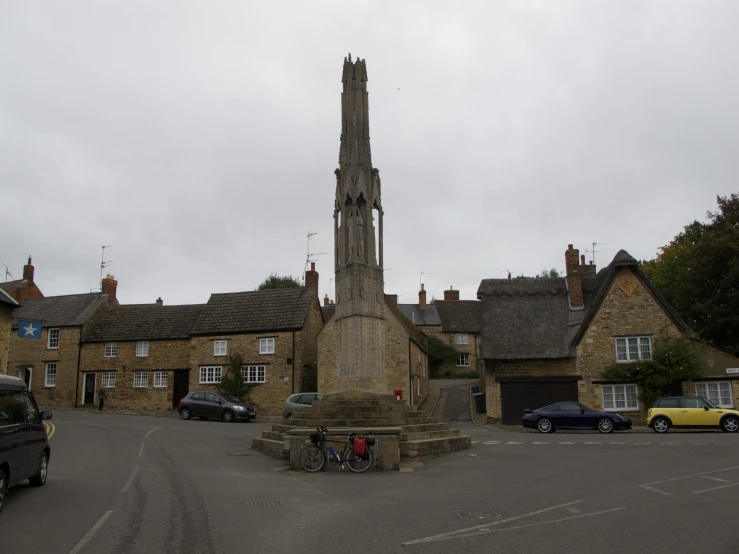 a building with a large tall tower near parked cars