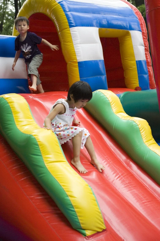 a small child climbing up on a jumping bouncer