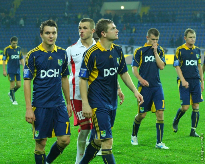 players from several teams walking across the field