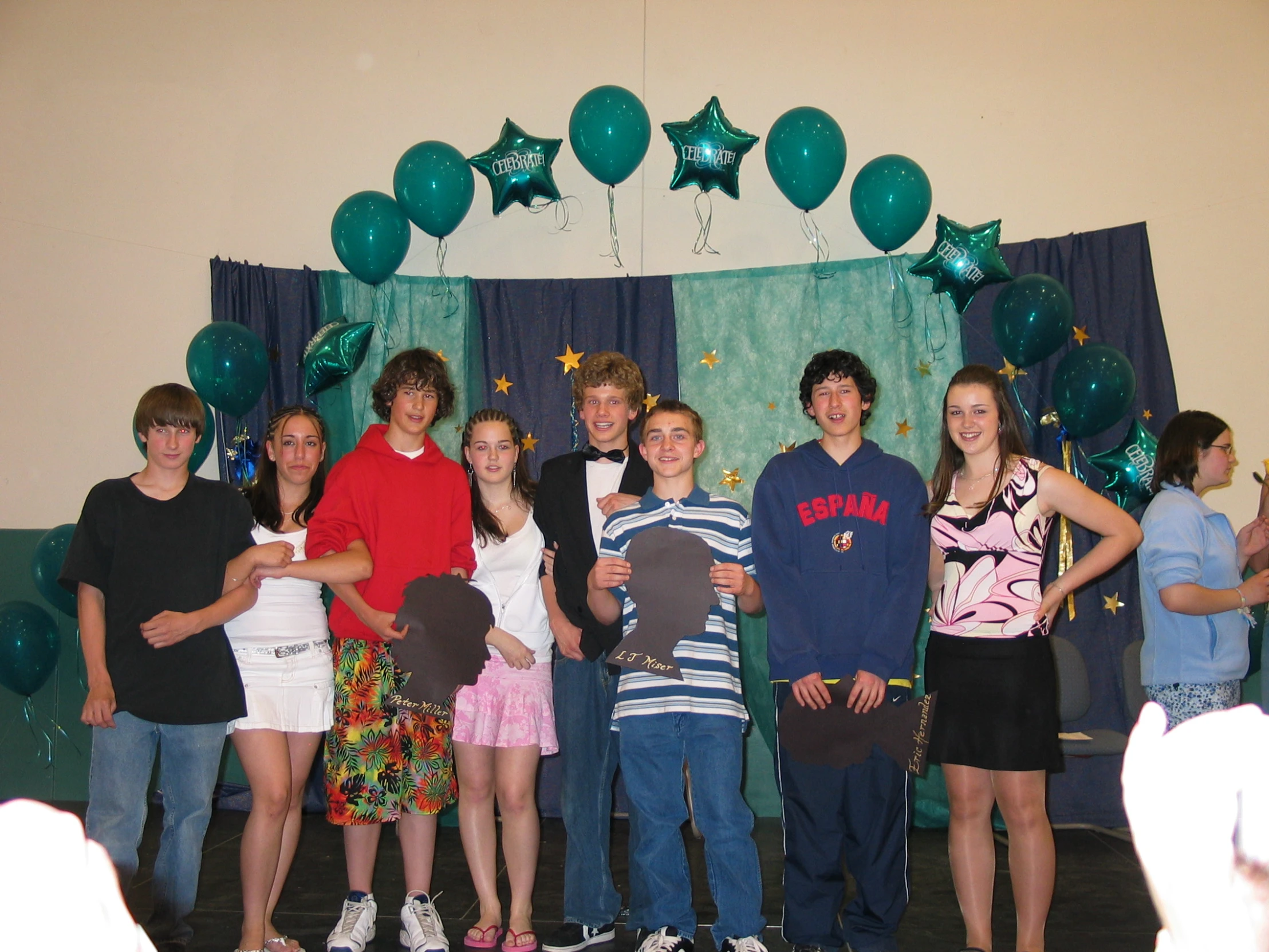 a group of s pose in front of balloons on a stage