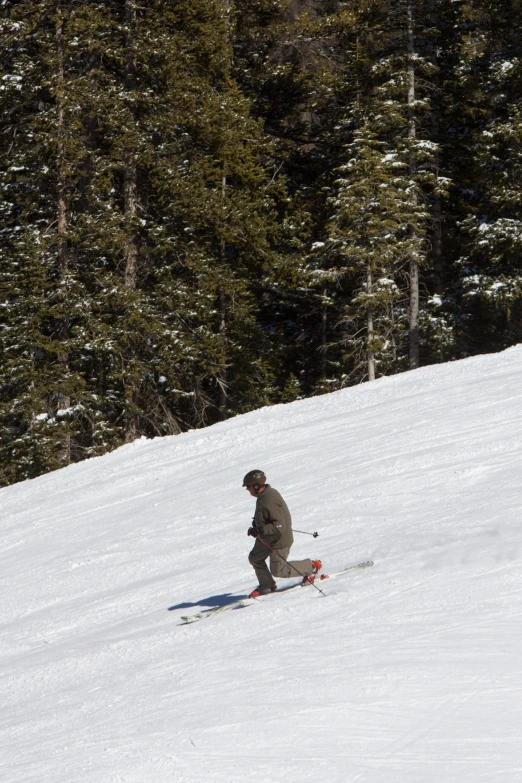 a man that is standing in the snow with some skis