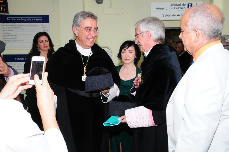 a priest is greeting people at the church