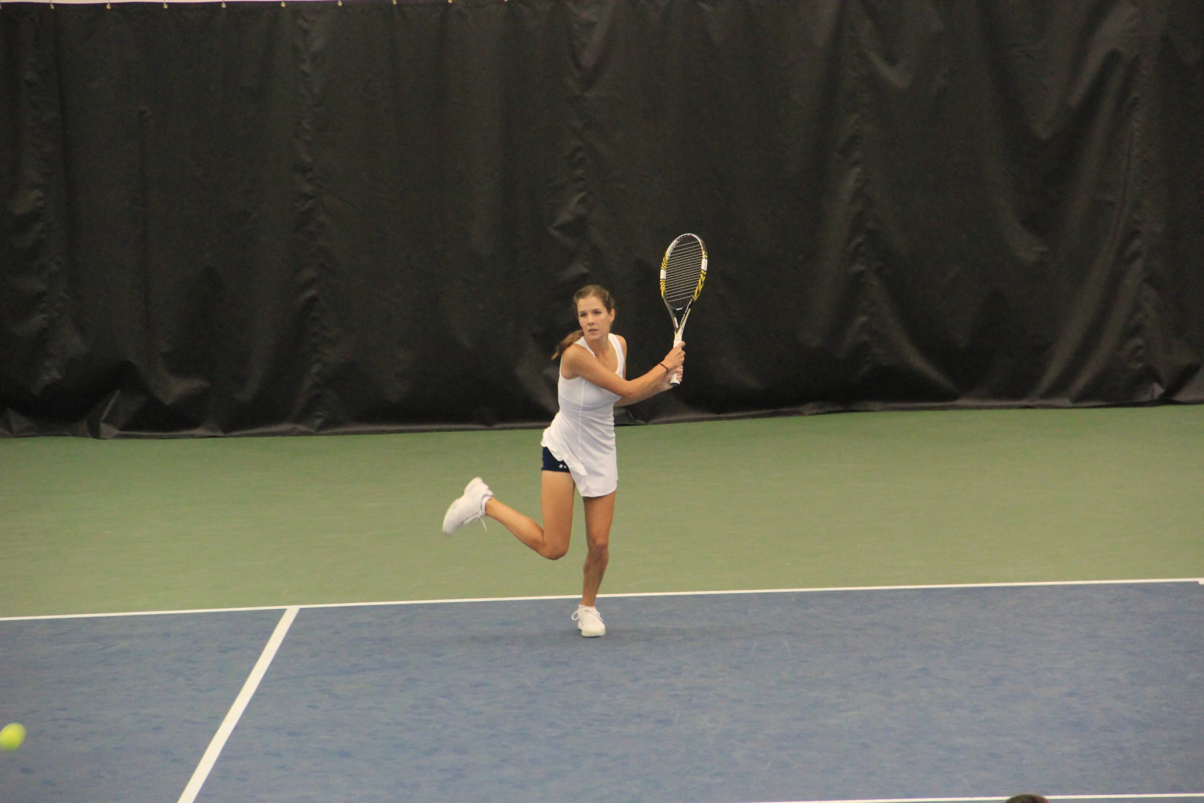 a woman on a tennis court playing a game