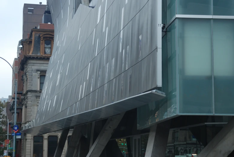 the corner of a city street with traffic and pedestrians