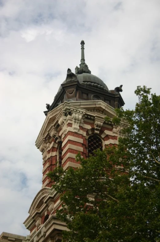 a building with a very tall tower next to trees