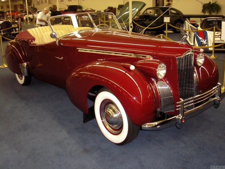 a vintage car sits on display in a building