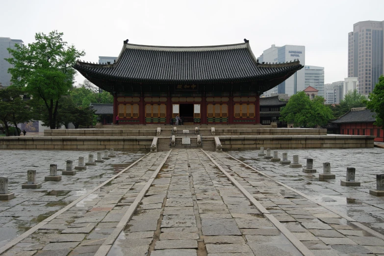 a pagoda is sitting on top of an old stone courtyard