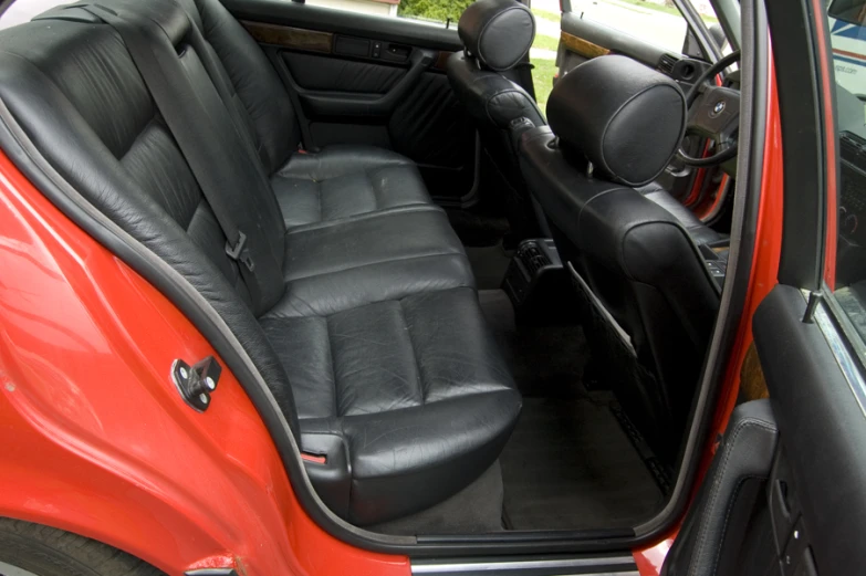 an orange car with black leather and a red interior