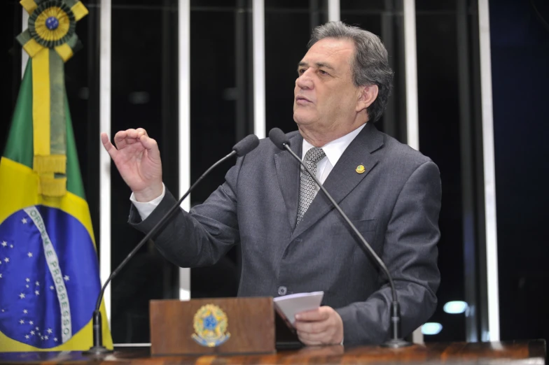 a man in a suit and tie giving a speech