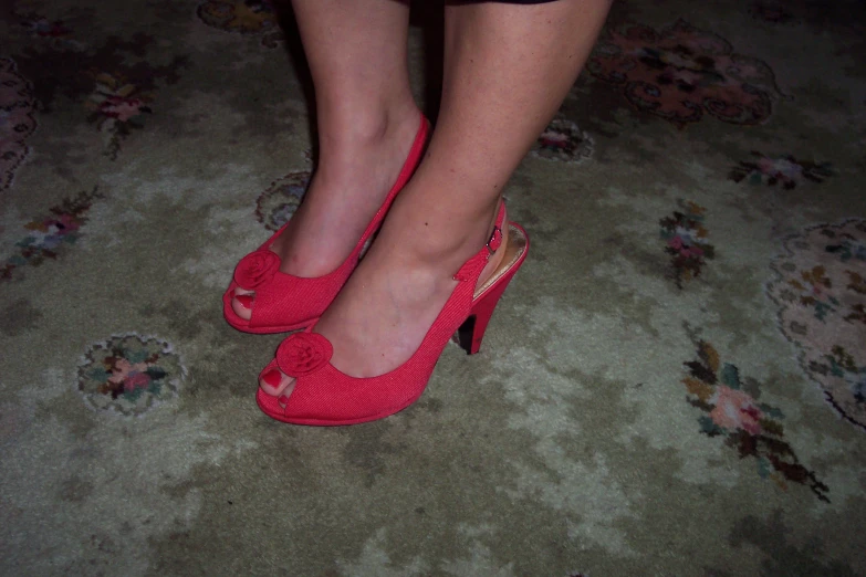 a close up of a person's legs with heels