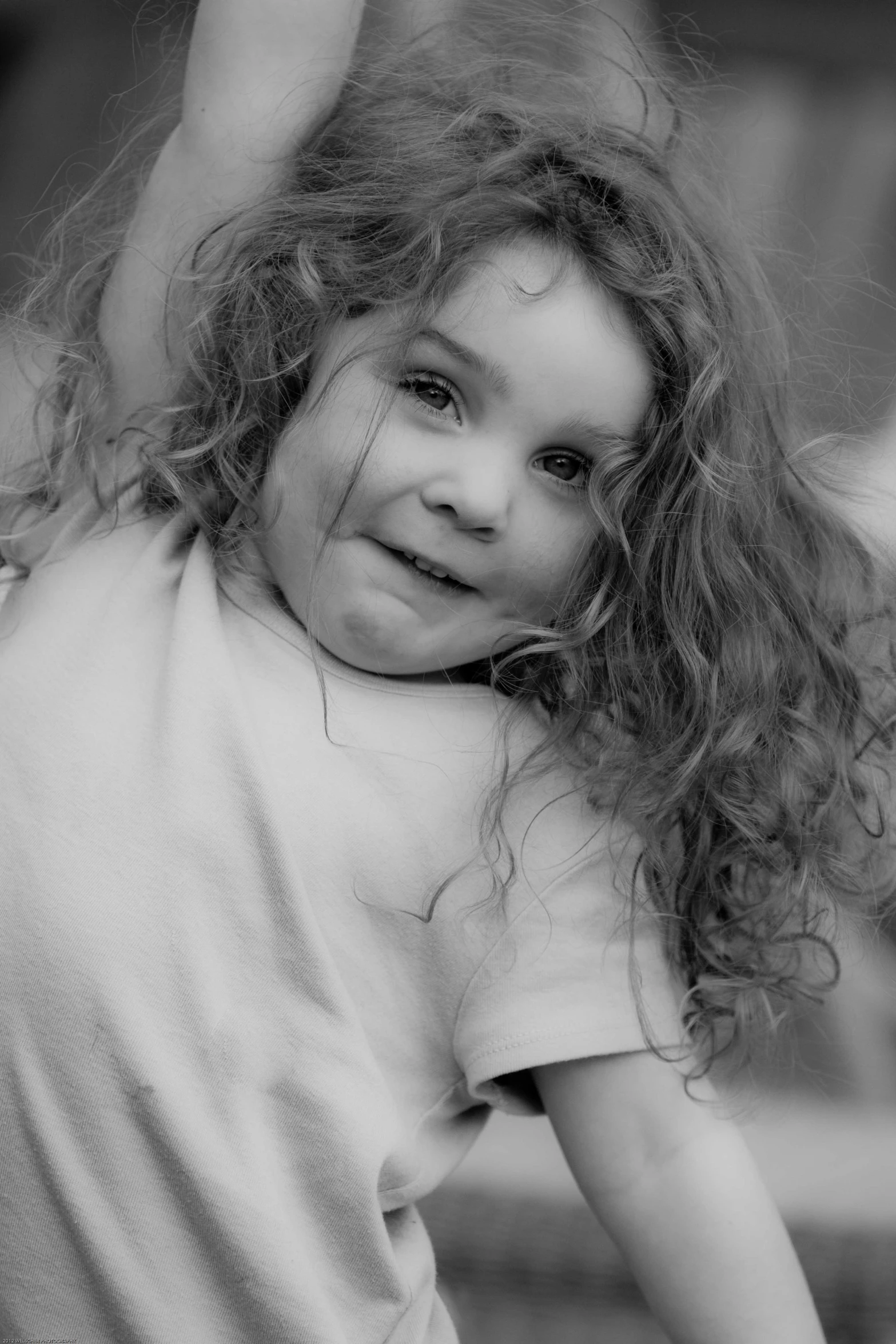 a close up of a child holding an object in her hand