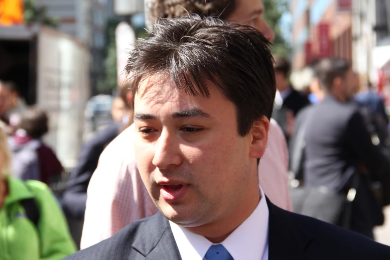 a young man in business attire wearing a tie