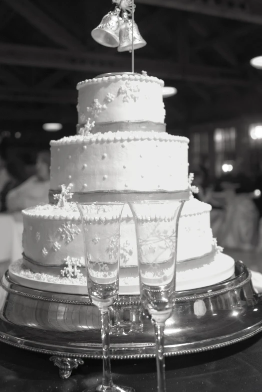 a triple layer white cake with a bow on top