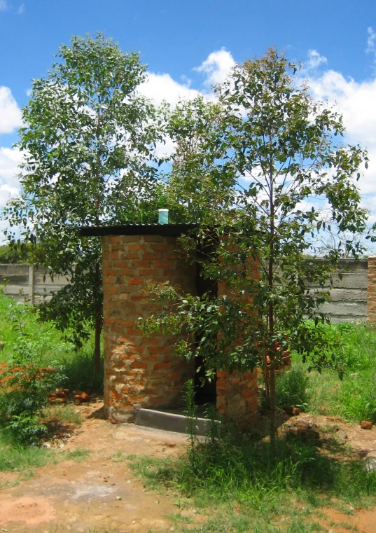 a building is seen surrounded by a field and trees