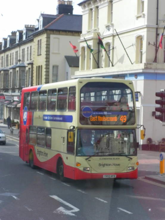 the double deck tour bus is driving down the street