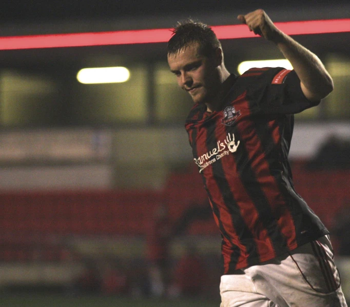 a man celeting a goal with his hands in the air